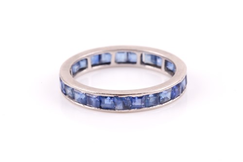 Lot 90 - A white metal and sapphire full eternity ring,...