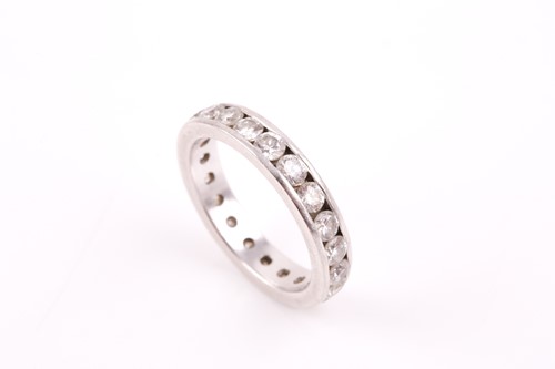 Lot 116 - A platinum and diamond eternity ring, set with...