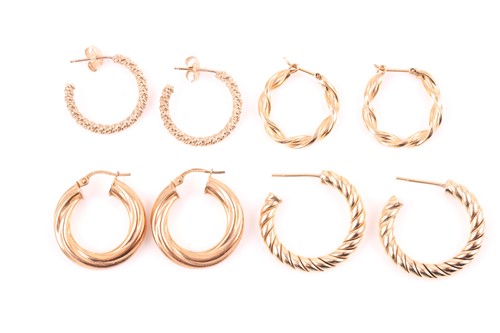 Lot 150 - A pair of yellow metal rope-twist hoop...