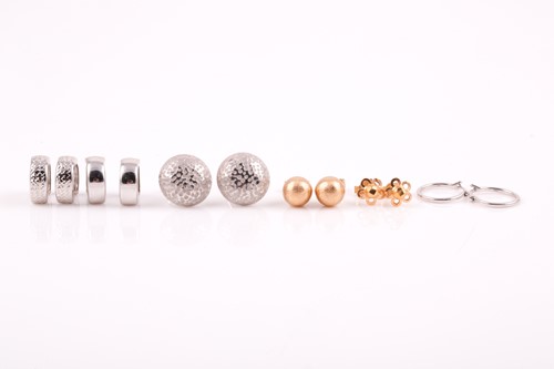 Lot 79 - A pair of white metal hollowed dome earrings,...