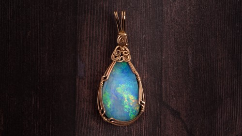 Lot 206 - A yellow metal and doublet opal pendant, the...