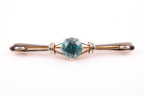 Lot 104 - A white and yellow gold and blue zircon brooch,...