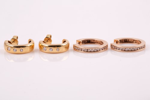 Lot 6 - A pair of yellow metal and diamond half hoop...
