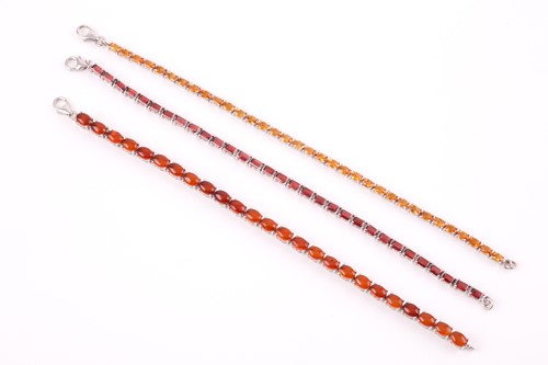 Lot 181 - A silver and garnet line bracelet, set with...