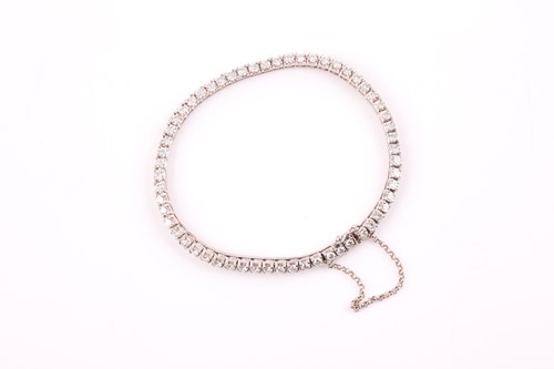 Lot 147 - A diamond line bracelet, set with round...
