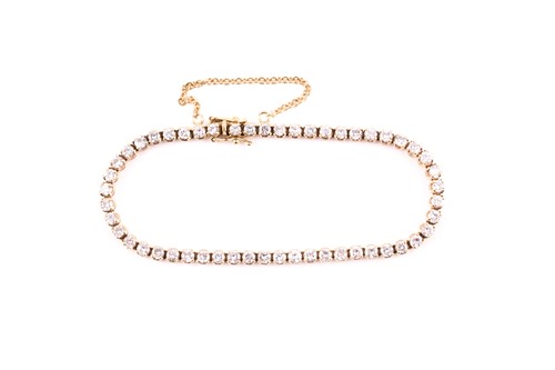 Lot 163 - An 18ct yellow gold and diamond line bracelet,...