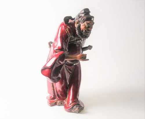 Lot 105 - A Shiwan flambe glaze figure of Guandi, mid...