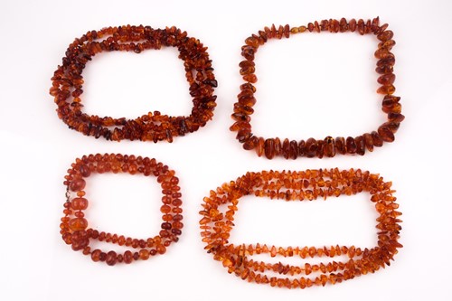 Lot 110 - A treated amber necklace, of naturalistic...
