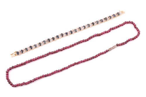 Lot 185 - A silver gilt and sapphire line bracelet, set...