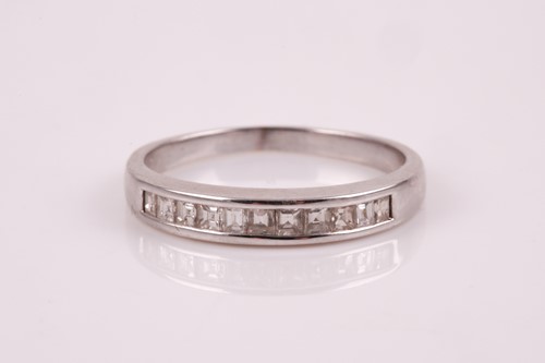 Lot 268 - A white gold and diamond half eternity ring,...