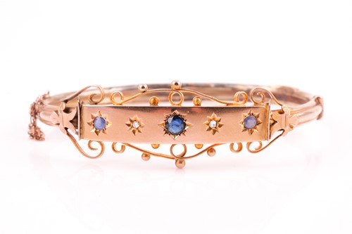 Lot 395 - An Edwardian five stone half hoop sapphire and...