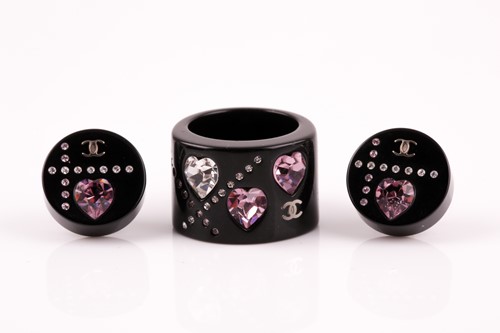 Lot 300 - Chanel. A black plastic and rhinestone...