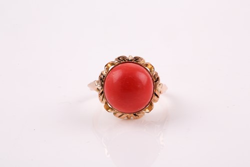 Lot 135 - A Continental yellow metal and coral ring, set...