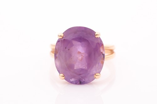 Lot 247 - A single stone amethyst dress ring, the deep...