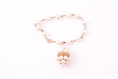 Lot 6 - A yellow metal and pearl bracelet, set with...
