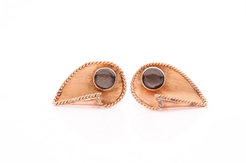 Lot 7 - A pair of yellow metal cufflinks, of stylised...