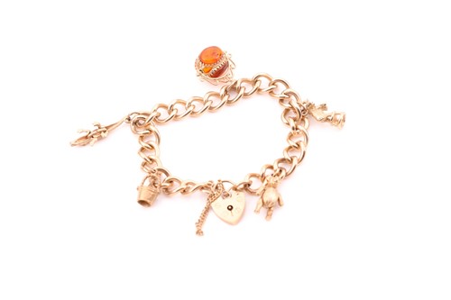 Lot 90 - A 9ct yellow gold curb-link charm bracelet,...