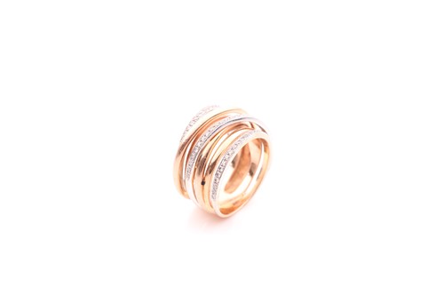 Lot 217 - An 18ct yellow and white gold and diamond band...