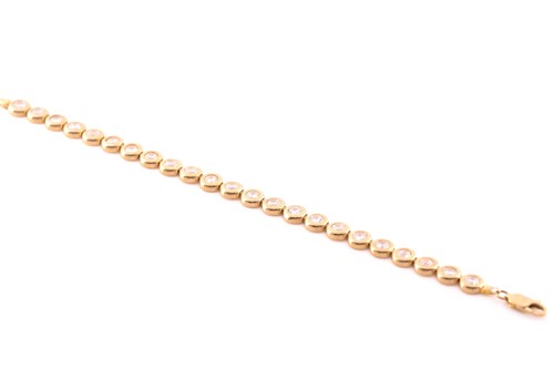 Lot 177 - A 9ct yellow gold and cubic zirconia line...