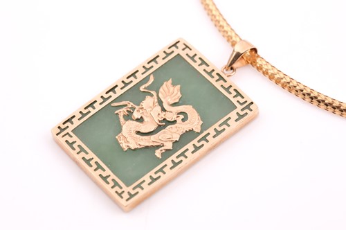 Lot 16 - A yellow metal mounted green jade pendant, the...