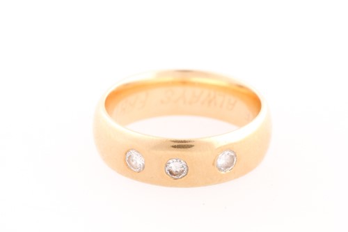 Lot 77 - A three stone diamond ring; the three round...