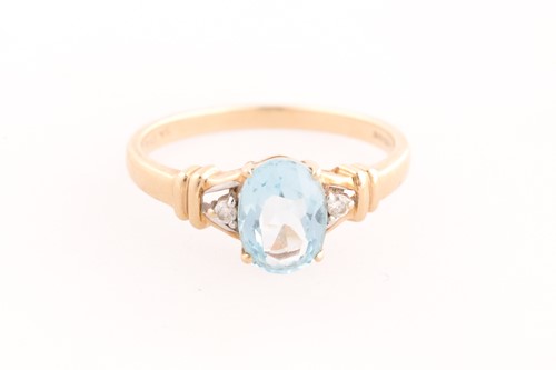 Lot 242 - A 9ct yellow gold, diamond, and blue topaz...