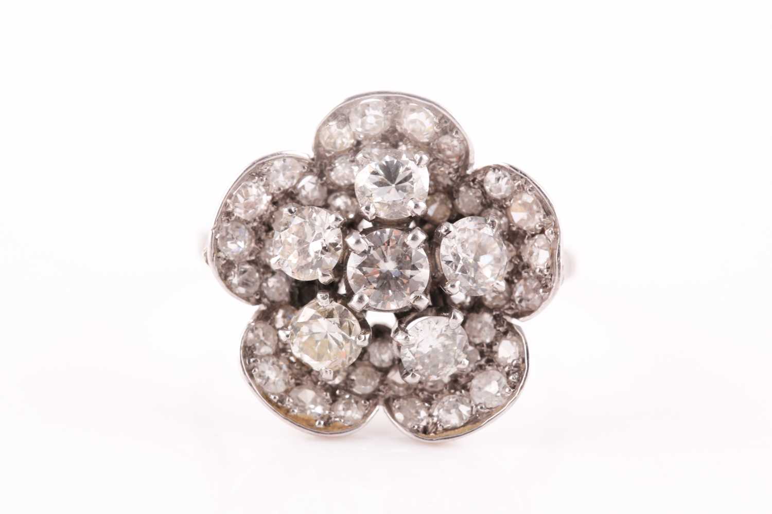 Lot 1 - A platinum and diamond floral cluster ring,...