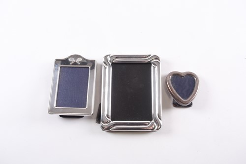 Lot 384 - Three silver photograph frames, one rounded...