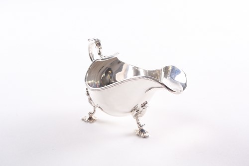 Lot 383 - Asprey. A George II style silver sauce boat....