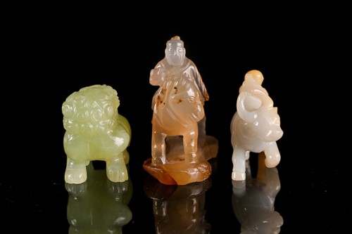 Lot 128 - A Chinese carved sepia/grey jade figure of "a...