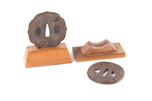 Lot 106 - A Japanese iron wood grain Tsuba, 19th century,...