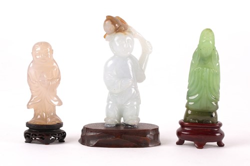 Lot 149 - A Chinese carved blue-green jade figure of a...