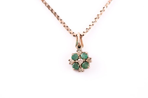 Lot 148 - A yellow metal, emerald, and white stone...