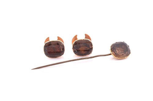 Lot 233 - A pair of yellow metal studs set with...