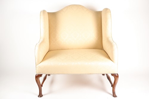 Lot 292 - A George I walnut camel backed love seat. With...