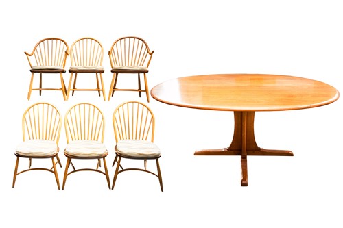 Lot 329 - An Ercol golden dawn light elm oval dining...