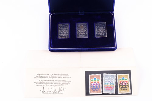 Lot 253 - A cased set of three silver ingots, designed...