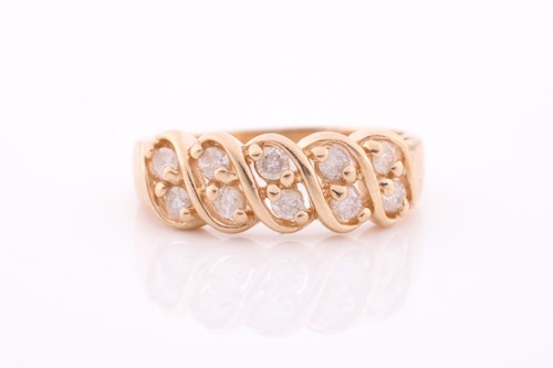Lot 139 - A yellow metal and diamond ring set with two...