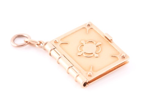 Lot 176 - A yellow gold pendant in the form of a book,...