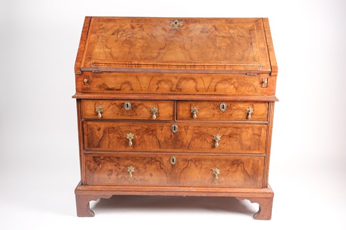 Lot 121 - A George I walnut fall front writing bureau,...