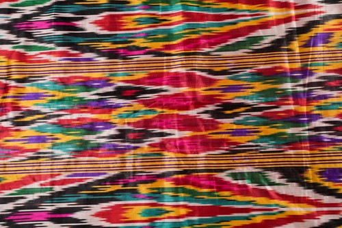 Lot 388 - A brightly coloured rectangular Ikat style...