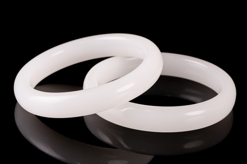 Lot 163 - A pair of matching of white carved jade...
