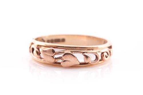 Lot 234 - A 9 ct and rose gold Clogau band ring, size Q,...