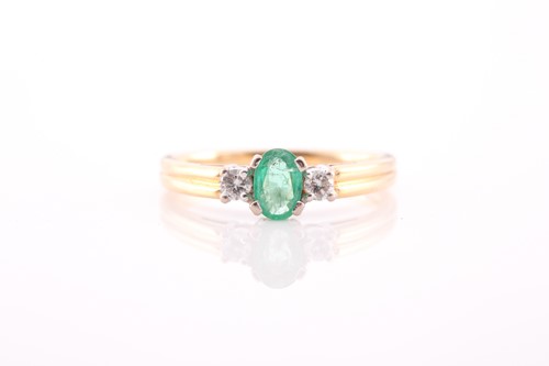 Lot 137 - A modern 18ct gold, emerald and diamond three...