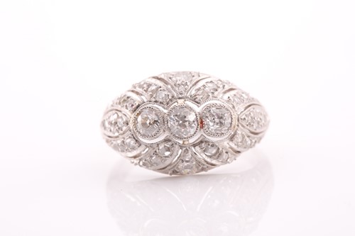 Lot 235 - A platinum and diamond bombe ring, with a...