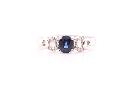 Lot 28 - A sapphire and diamond ring; the central oval...