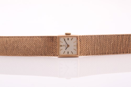 Lot 387 - Omega, a lady’s 9ct gold integral bracelet...