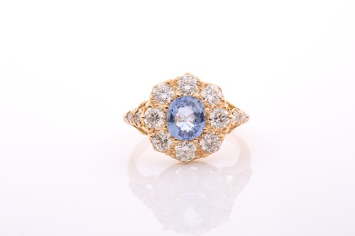 Lot 152 - A modern sapphire and diamond oval cluster...