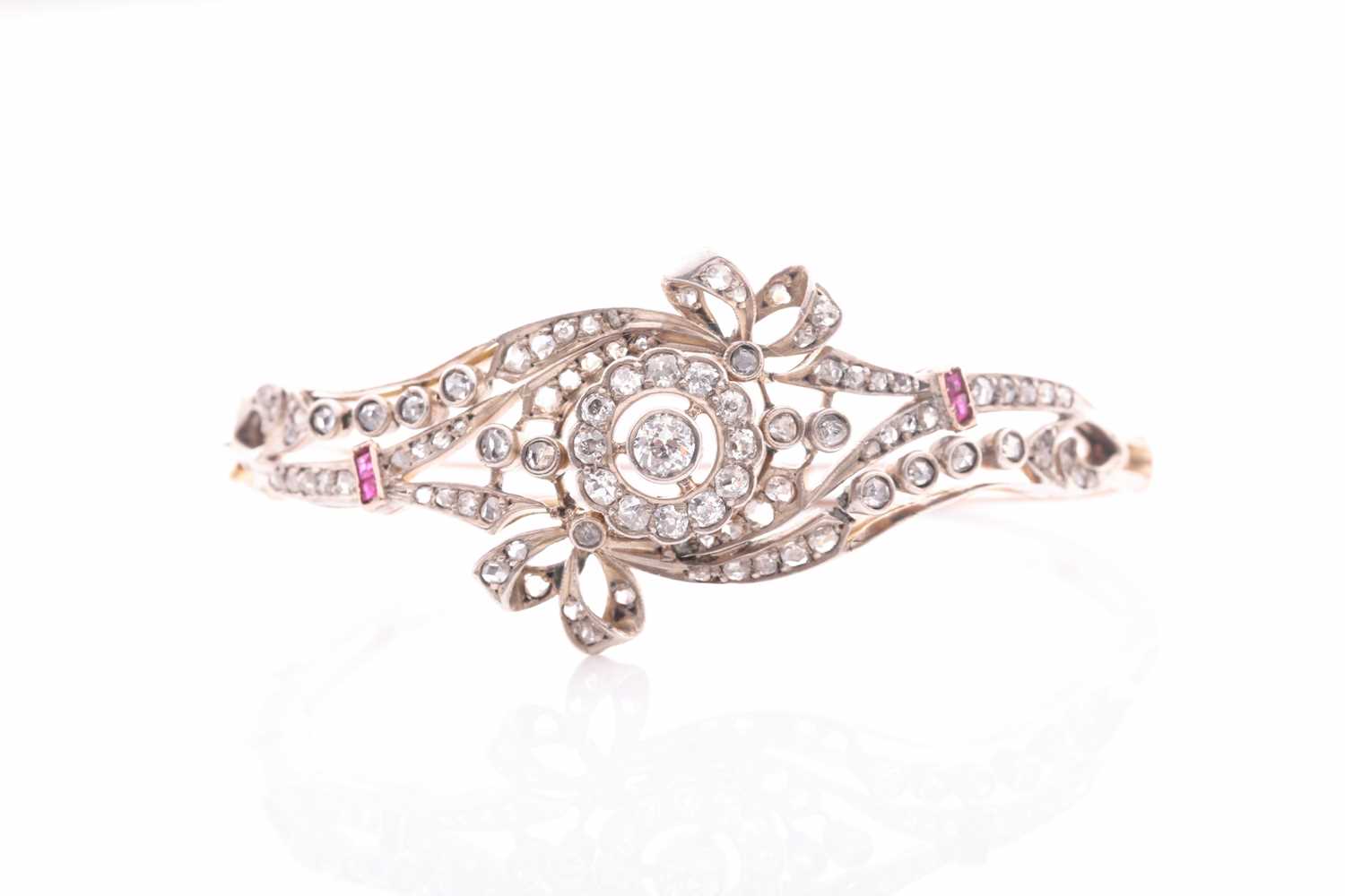 Lot 430 - A late Victorian diamond and ruby bangle, the...