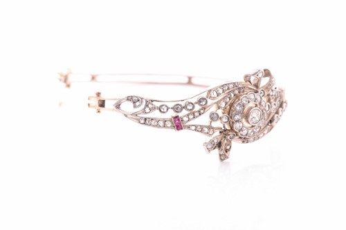 Lot 430 - A late Victorian diamond and ruby bangle, the...